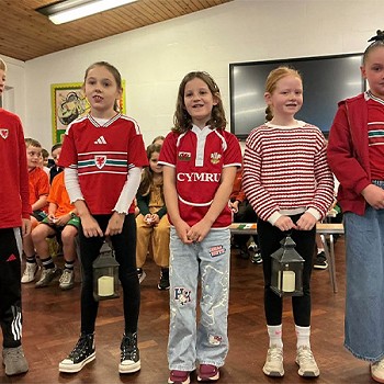 Five children from year 3 and 4 taking part in an assembly