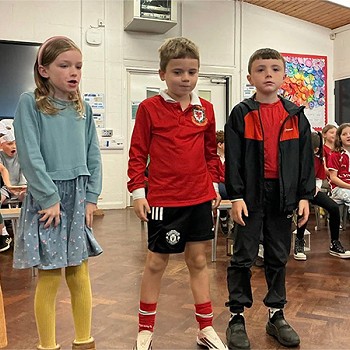 Five children acting as part of the year 3 and 4 assembly
