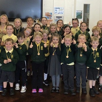 group of children wearing medals