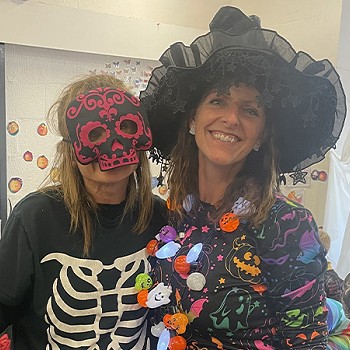 Two teachers have dressed up for the year 1 and 2 halloween disco