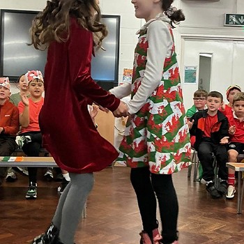 Two girls dancing together in the assembly