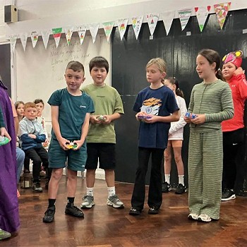 Group of children acting as part of the year 3 and 4 assembly