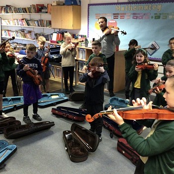 tutor and children playing violins