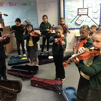tutor and children playing violins